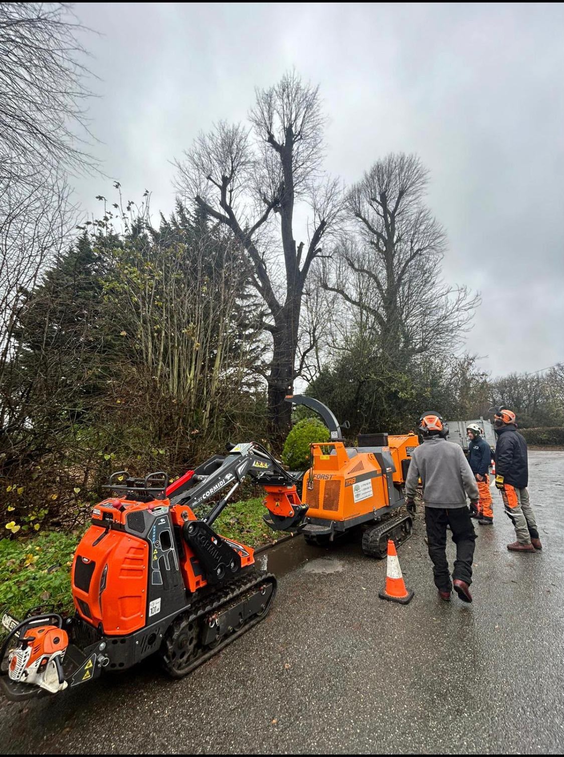 Tracked mini-loader and wood chipper set up on site